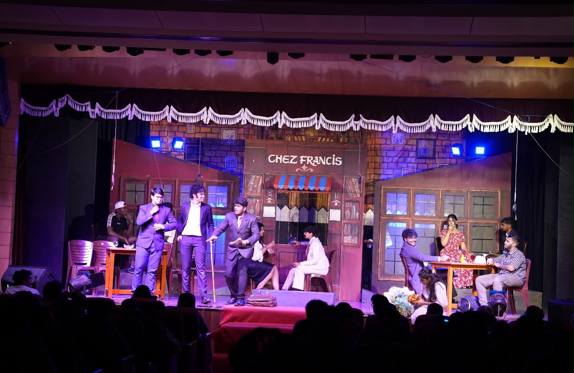 Theatre performance on stage with a cafe set