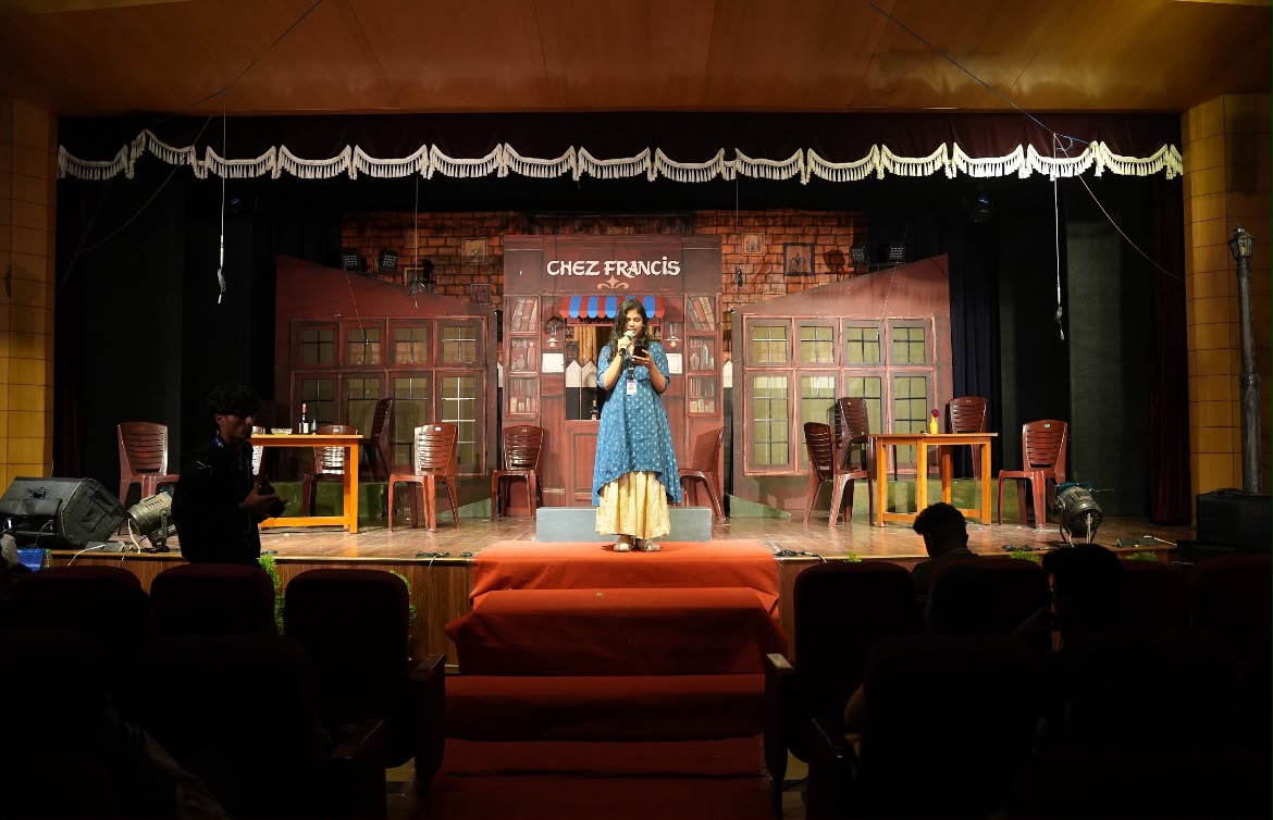 Student performing alone on a lit stage